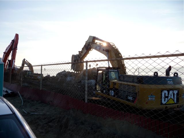 Three backhoes