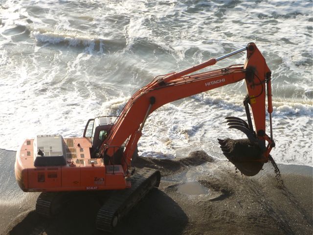 Backhoe at the ocean